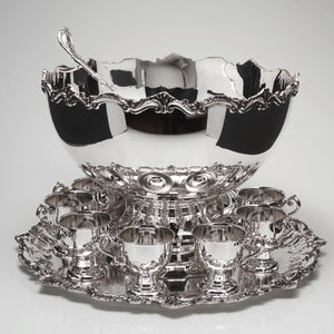 Silverplated punch bowl with tray and 10 serving cups.