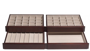 The top and second drawers consist of twenty 2 x 2 squares for earrings. The third drawer caters to rings with eight ring bars, accommodating up to seven rings each. The bottom drawer is simply open for large or formed necklaces, bracelets, and brooches.